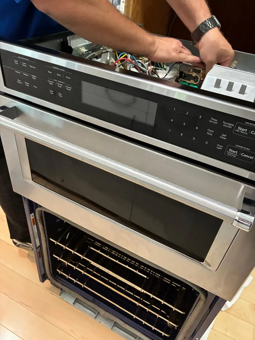 Technician working on a microwave/oven combo unit