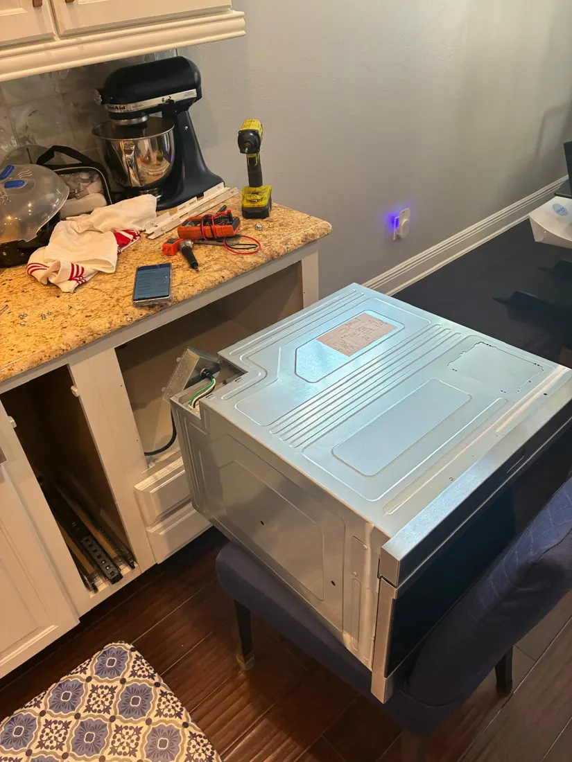 Built-in microwave pulled out for inspection